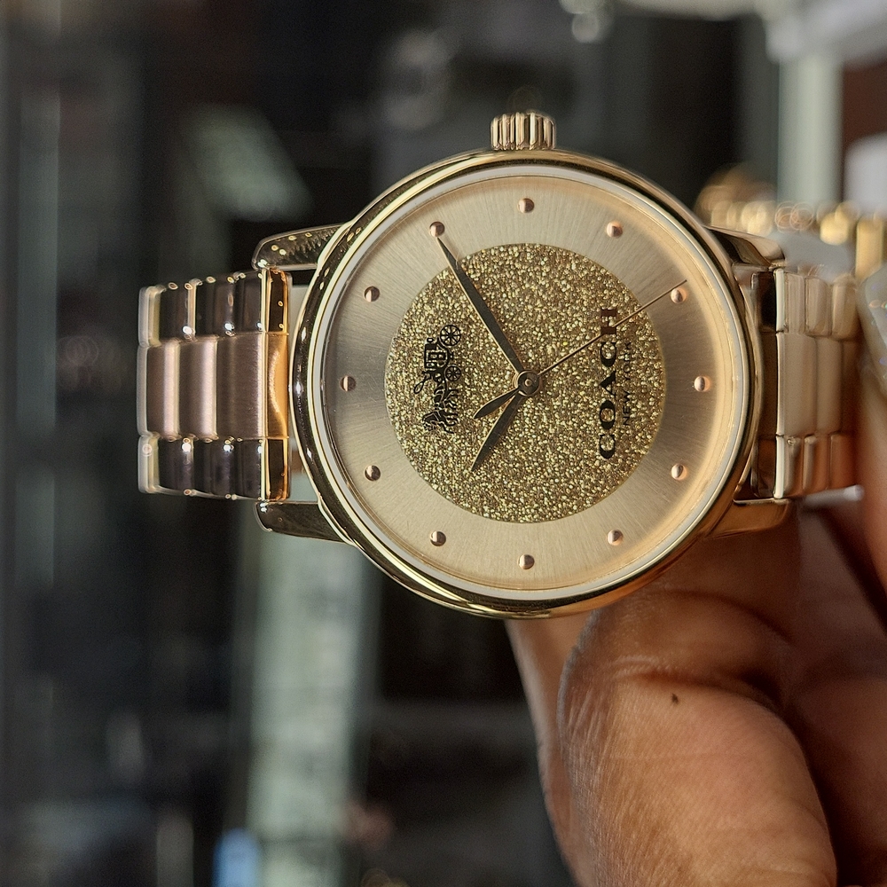 Women rose gold coach watch.